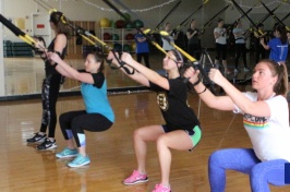 students working out with straps in the gym