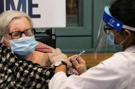 Photo of elderly woman receiving the COVID-19 vaccination