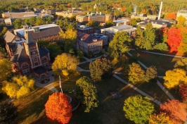 Drone shot of UNH campus with brilliant autumn colors