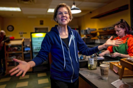Elizabeth Warren stands in a NH coffee shop
