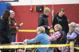 New Hampshire residents wait in line at a polling location