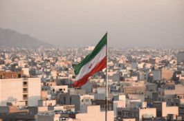 Iranian flag flies above a city in Iran