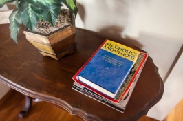 Photo showing an alcoholics anonymous handbook on a table.