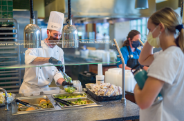 student being served in one of UNH's dining halls