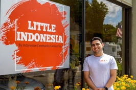 student standing outside Little Indonesia storefront in Somersworth