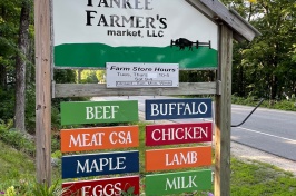 A sign showing a local farm store information