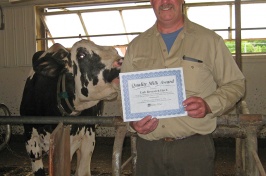 Jon Whitehouse with cow and award