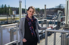 Paula Mouser stands on catwalk at Durham's wastewater treatment facility