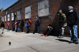 People wait in line to receive assistance 