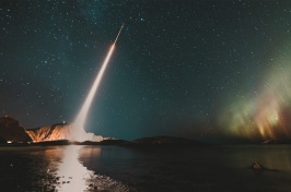 Rocket launches into the green Northern Lights.