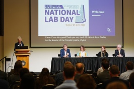 A panel of National Lab scientists talk under a slide that says "UNH DOE National Lab Day