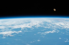 Image of moon above Earth's surface from space.