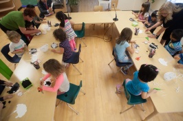 A photo showing a childcare provider's classroom filled with children and instructors