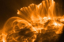 Orange flares of light erupt from the surface of the sun.