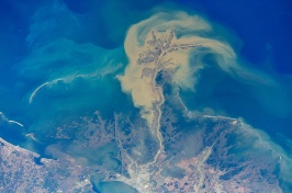 An aerial shot of discolored yellow water moving into the darker blue of the Gulf of Mexico. 