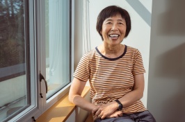 Ju-Chin Huang sits by a window inside her office.