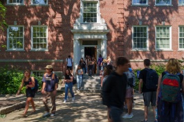Students moving in and out of a campus building