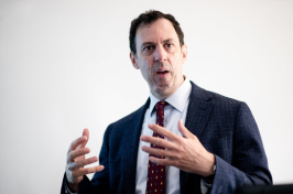UNH Associate Professor Stephen Ciccone leads a lecture at the front of the classroom. 