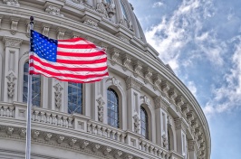 Stock photo of the American flag in front of the US Capitol building