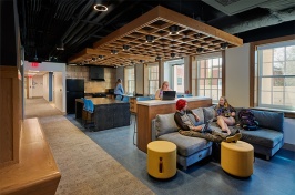 Students sitting in a lounge space inside a residence hall