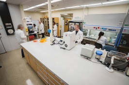 Time lapse photo of several scientists working in a lab