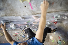 Rock climber shot from above at an indoor rock wall