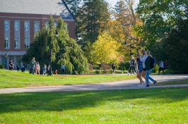Students walking on campus path in spring