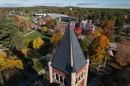 Aerial view of Thompson Hall tower with colorful fall trees and campus buildings in the background