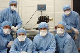 students in medical gowns and masks