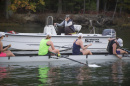 Coach in motorboat calls to four women in rowing shell