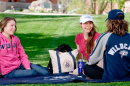 students on unh great lawn with unh purchases