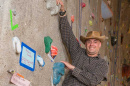 UNH graduate Bill Cudmor on climbing wall