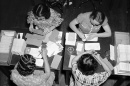In this historic photo from the Library of Congress, workers in the Social Security Board Records Office check for any errors in their files.