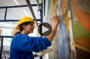 UNH art history graduate Corinne Long '12 restoring a mural in Hamilton Smith Hall at UNH