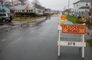 Flooded road with hazard sign in front