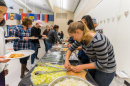 students serving food at international luncheon