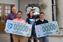 UNH students Jose Calvo of Goffstown, Christian Merheb of Derry, Andrea Plourde of Pembroke and Brennan Pouliot of Goffstown, along with Gnarlz, show off the new UNH license plate decal options on the steps of the State House in Concord
