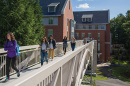 UNH students walking on the new pedestrian bridge connecting Hamilton Smith Hall with Dimond Library