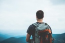 a male hiker looking out at the mountains