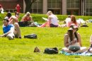 UNH students sitting on Thompson Hall lawn