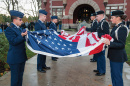 members of UNH ROTC holding an American flag