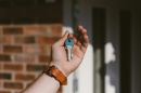 Image of a person  holding a key to a house
