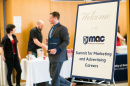 Students mill around the sign for the MAC SMAC conference