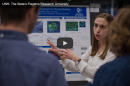 A female UNH student presenting her poster during the 2018 Interdisciplinary Science & Engineering Symposium at UNH