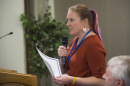 Postdoctoral researcher Kerri Seger speaks into a microphone