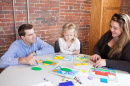 UNH neuropsychology students at a table with a young child 