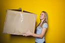 image of woman with moving box, pexels.com