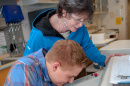 UNH Professor Emeritus Stacia Sower at work with a student 