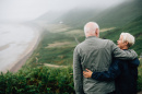Image of two people looking from a mountain at a beach