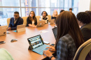 Image of people sitting in a conference room. 